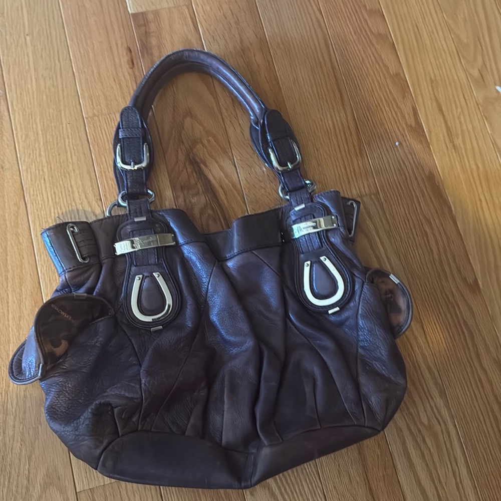 Purple leather bag with leopard interior.